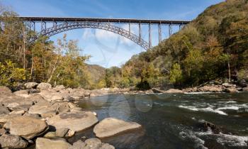 Rapids under the high arched New River Gorge bridge in West Virginia