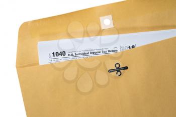 Printed copy of Form 1040 for income tax return in a plain brown envelope with copy space