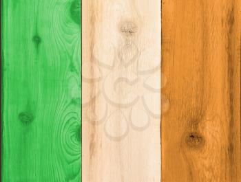 Timber planks of wood that have been painted or stained in the colors of a flag for Ireland or Eire as a background