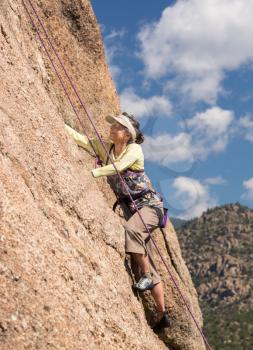 Senior female climber on rope assisted climb on Turtle Rocks near Buena Vista Colorado