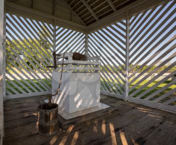 Shaded water well and wooden bucket at McLean House in Appomattox national park