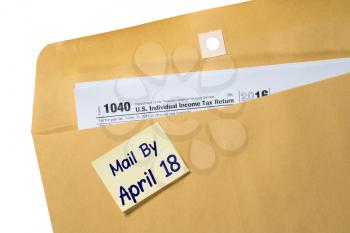 Printed copy of Form 1040 for income tax return with reminder for April 18 deadline