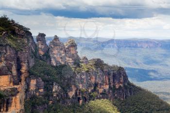 Sun illuminates the Three Sisters rock formation in the valley from Cliff View Lookout overlooking the majestic Blue Mountains near Sydney NSW Australia