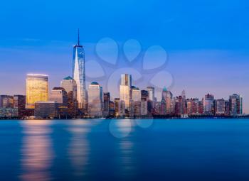 Skyline of lower Manhattan of New York City from Exchange Place at night with World Trade Center at full height of 1776 feet