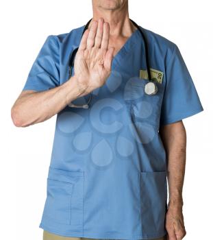 Senior caucasian doctor in scrubs refusing entry  for treatment and isolated against white background