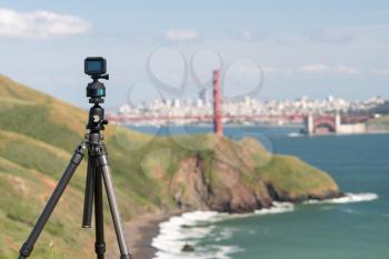 Focus on camera taking video or timelapse footage from Marin Headlands with the Golden Gate Bridge and San Francisco taken on clear spring day