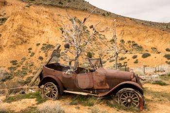 Remains of old car by quarry at entrance to the old town of Virginia City in Nevada, a center for gold and silver mining in the past