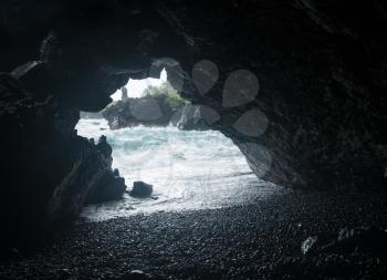 Sea cave entrance at Waianapanapa State Park on the road to Hana in Maui, Hawaii