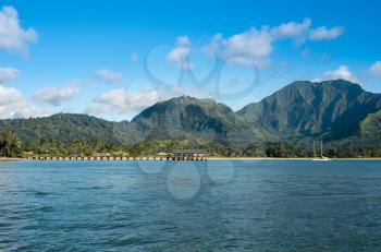 Afternoon from boat trip at Hanalei Bay and pier with the Na Pali coast in the background near Hanalei, Kauai, Hawaii