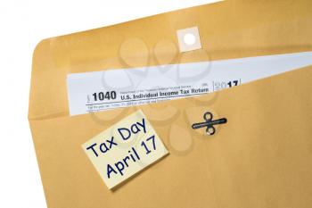 Printed copy of Form 1040 for income tax return for 2017 with reminder for April 17 deadline