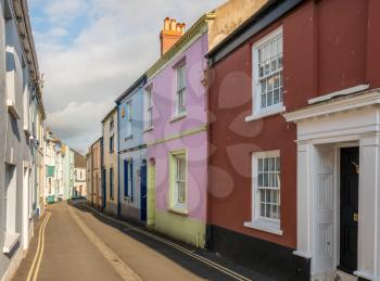 Old stone plaster and painted homes in narrow street in Appledore, Devon