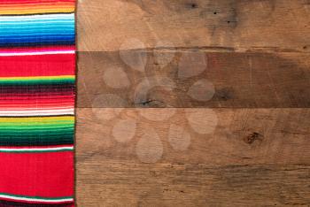 Cinco de Mayo background image on with serape cloth blanket on wooden rustic boards