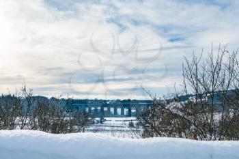 Snow covered trees frame the old Chirk railway bridge carrying rail lines