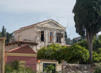 ATHENS, GREECE - 14 May 2019: House with statue in ancient neighborhood of Plaka in Athens by the Acropolis