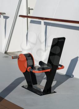 Exercise bicycle machine on the deck of a modern cruise ship