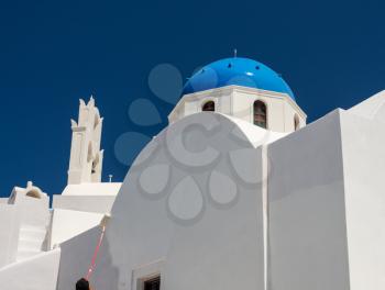 White paint being applied by roller to traditional house in Santorini