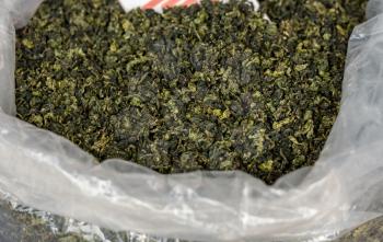 Large bag of green tea leaves drying inside Tulou in Fujian Province in China
