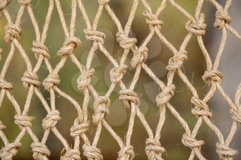 Close up of the knots on a traditional fishing net made by knotting ropes together