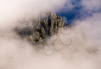 Fluted rocks of the Na Pali mountains through the clouds from Pihea trail near Pu'u O Kila lookout on Kauai