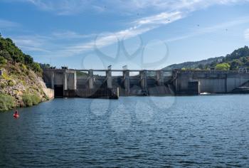 Solid structure of the Carrapatelo dam on River Douro in Portugal with the lock gates on the left