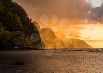 Sunset lights the receding cliffs of the NaPali coastline on north coast of Kauai in Hawaii