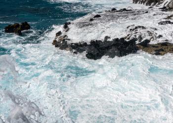 Foaming water on the shoreline of Ka'ena Point on the extreme west coast of Oahu in Hawaii