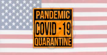 Pandemic sign warning of quarantine due to Covid-19 or corona virus in the USA using a US flag in the background