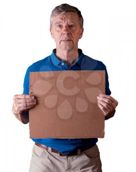 Senior caucasian man holding a blank cardboard sign for copy space message. He is isolated against a white background