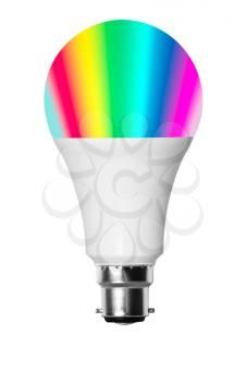 Isolated cutout smart LED bulb showing rainbow of colors with UK B22 bayonet fitting and set against white background