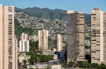 Hotels and apartments with houses crowded on the mountain side in the modern part of Waikiki on Oahu