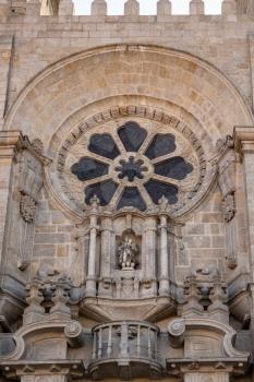 Stone carvings and window above main entrance to the old Cathedral or Se in Porto