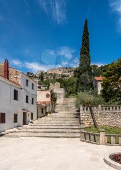 Church and square with fortress on hilltop in the coastal town of Novigrad in Croatia
