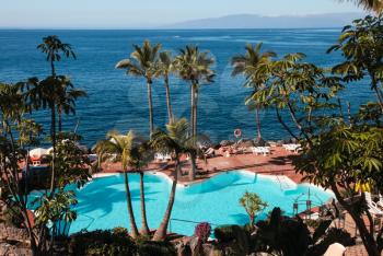 Costa Adeje, Tenerife, Spain - July 28, 2013: The islands of Tenerife is a resort for tourists. Coast of the sea and hotels on the beach.
