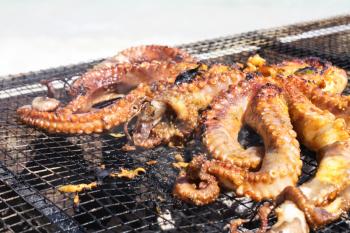 Grilled octopus with vegetables and seafood. Cooking seafood in the open air
