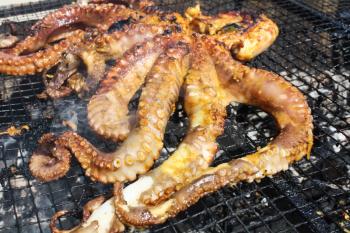 Grilled octopus with vegetables and seafood. Cooking seafood in the open air