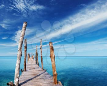 Wooden pier on a tropical island, sea and blue sky, Thailand
