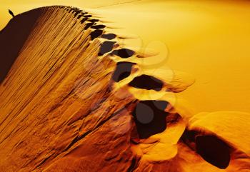 Footprints on sand dune, Sahara Desert, Algeria

