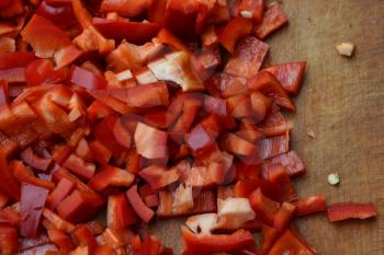 Pepper. Capsicum annuum. Slices of red pepper. Close-up. Splitting. On a cutting board. Delicious. Horizontal photo