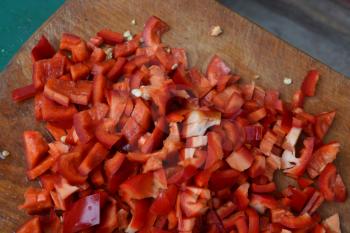 Pepper. Capsicum annuum. Slices of red pepper. Close-up. Splitting. On a cutting board. Kitchen. Delicious. Horizontal