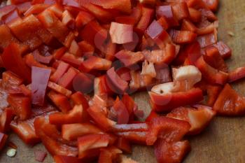 Pepper. Capsicum annuum. Slices of red pepper. Close-up. Splitting. On a cutting board. Kitchen. Horizontal photo