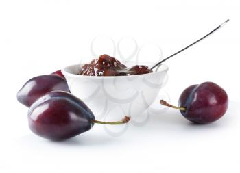 Ripe plums and jam on white background