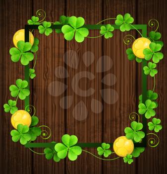 Clover leaves and golden coins in green frame on a wooden background. Design for St. Patrick's day.