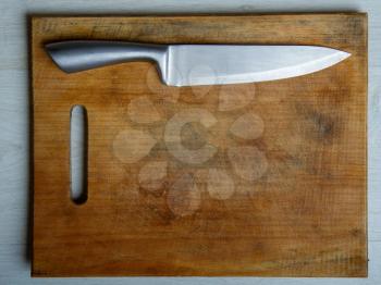 wood cutting board and sharp steel knife top view