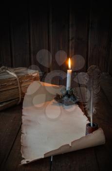 vintage paper scroll on a wooden table a feather for writing by candlelight