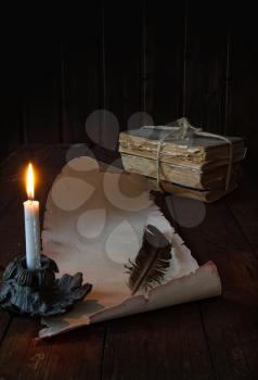 vintage paper scroll on a wooden table a feather for writing by candlelight