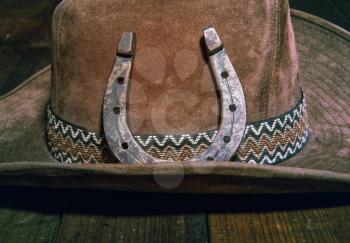 steel classic horseshoe lying on a brown cowboy hat close-up