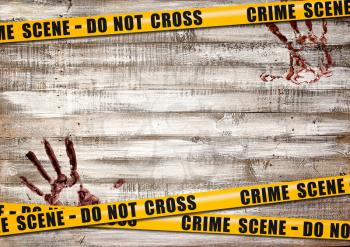 A light wooden background with yellow poleciles prohibiting passage and bloody handprints on it