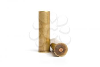 two old brass shot cartridges of a twelfth caliber hunting rifle on a white background