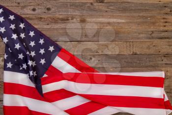 starry striped flag of United States of America on rough wooden background