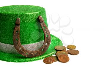 classic green leprechaun hat and a few different coins on a white background